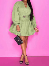a woman in a green dress posing for a picture