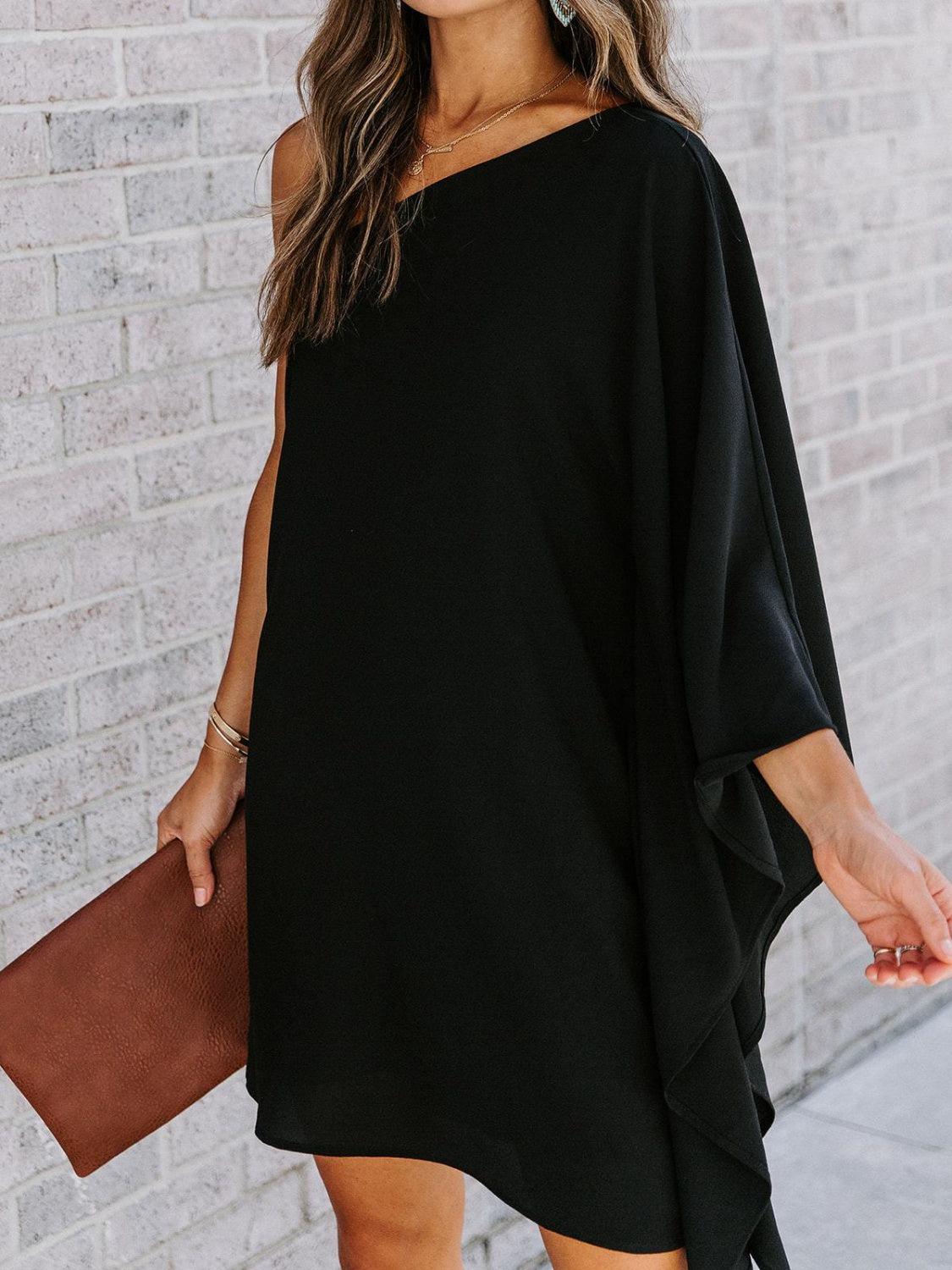 a woman wearing a black one shoulder dress