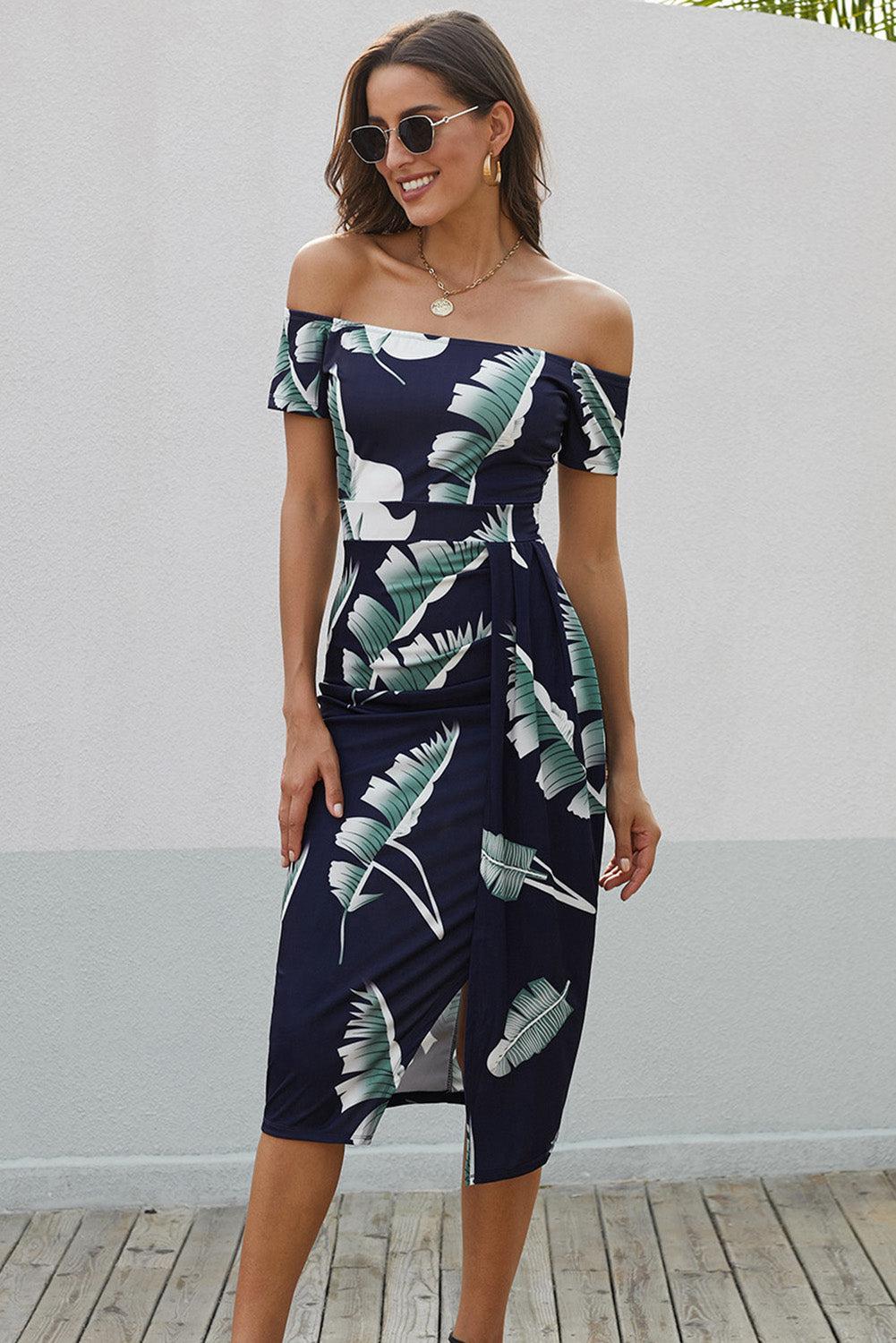 a woman wearing a dress with a tropical print