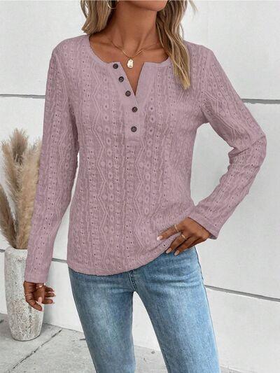 a woman wearing a pink sweater and jeans