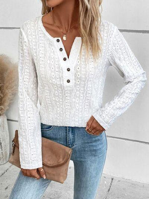 a woman wearing a white sweater and jeans