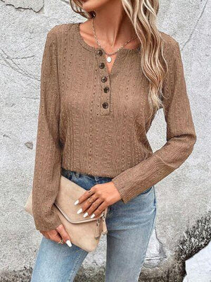 a woman wearing a brown sweater and jeans