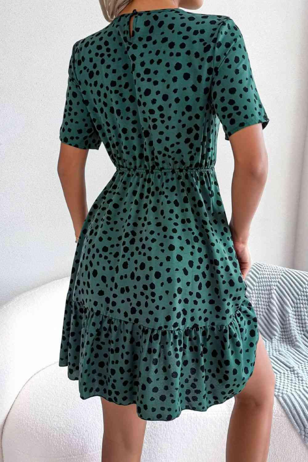 a woman wearing a green polka dot dress