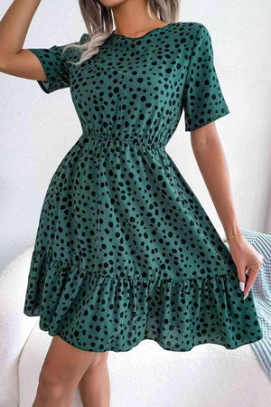 a woman wearing a green polka dot dress