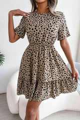 a woman wearing a dress with a polka dot pattern