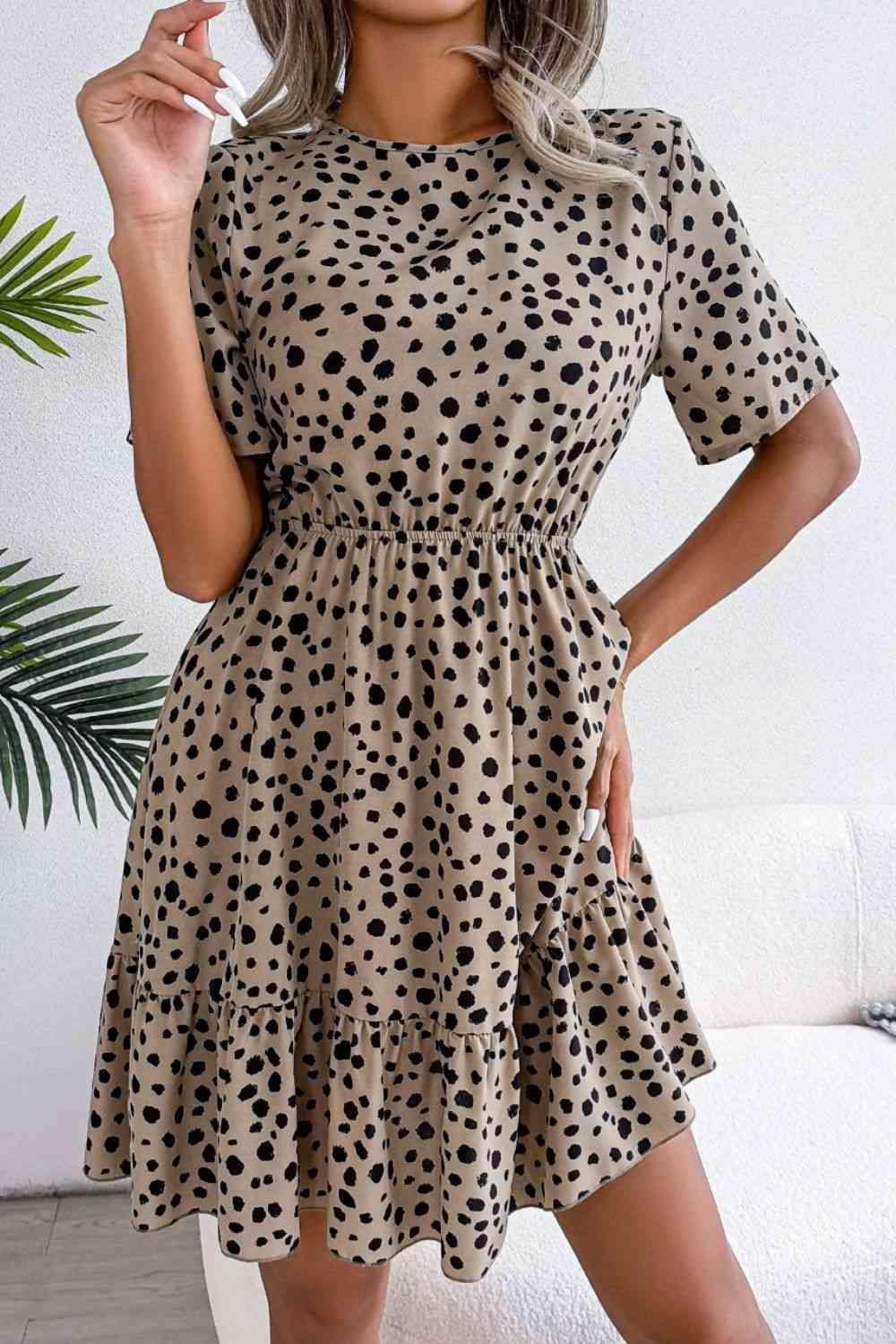 a woman wearing a dress with a polka dot pattern