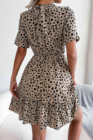 a woman wearing a dress with a polka dot pattern