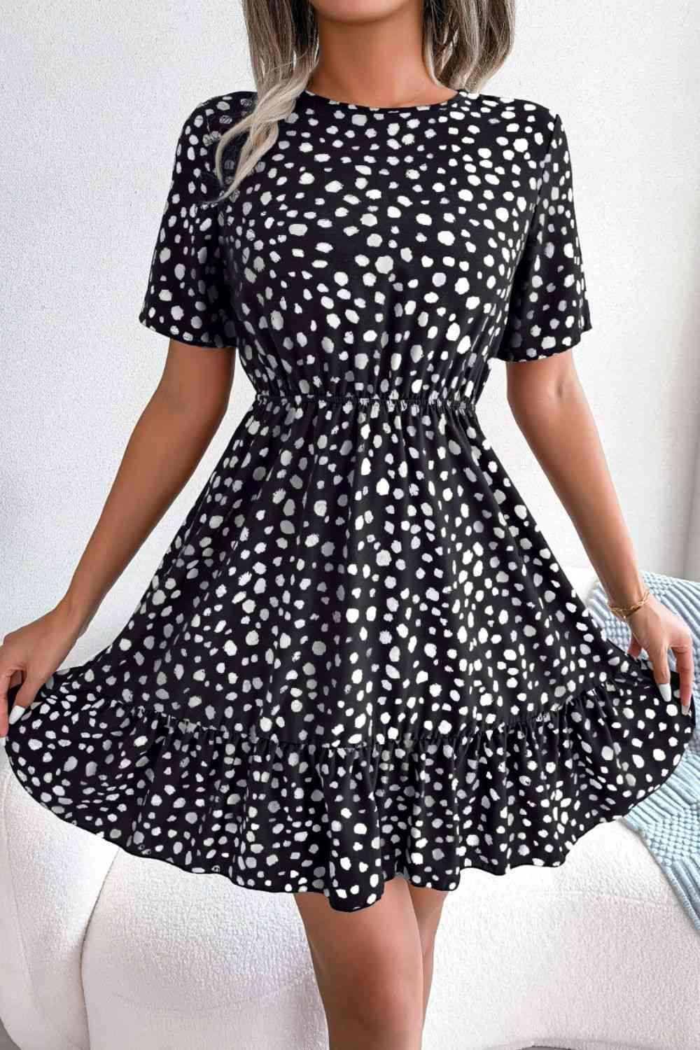 a woman wearing a black and white polka dot dress