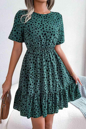 a woman wearing a green polka dot dress