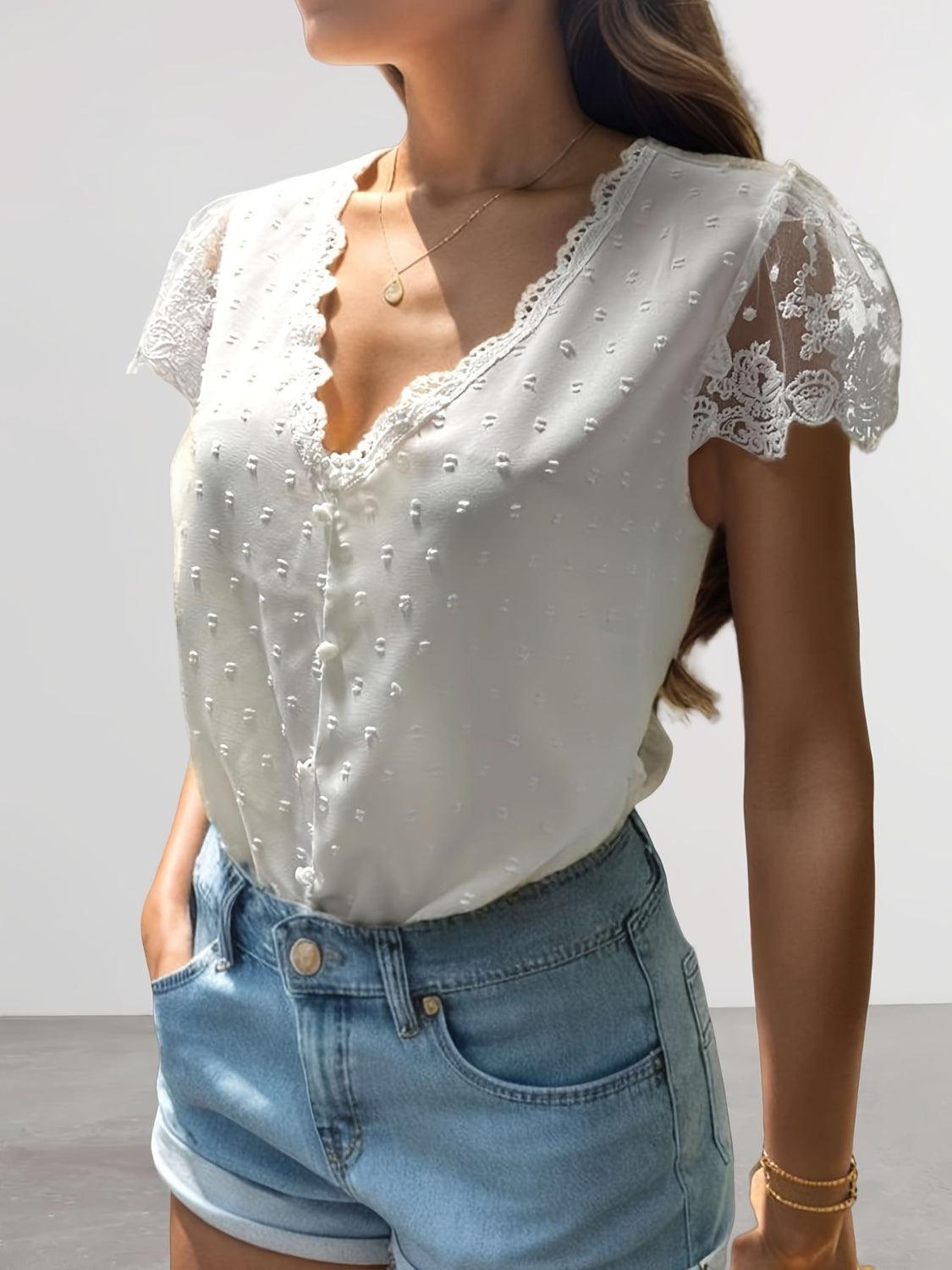 a woman wearing a white blouse and denim shorts