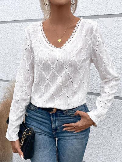 a woman wearing a white blouse and jeans