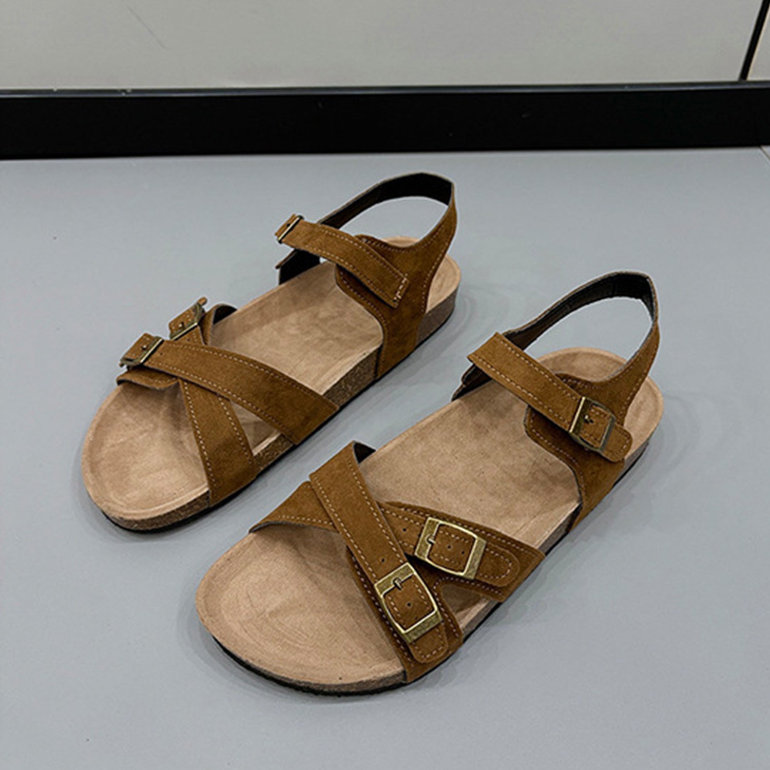 a pair of brown sandals sitting on top of a table