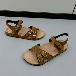 a pair of brown sandals sitting on top of a table