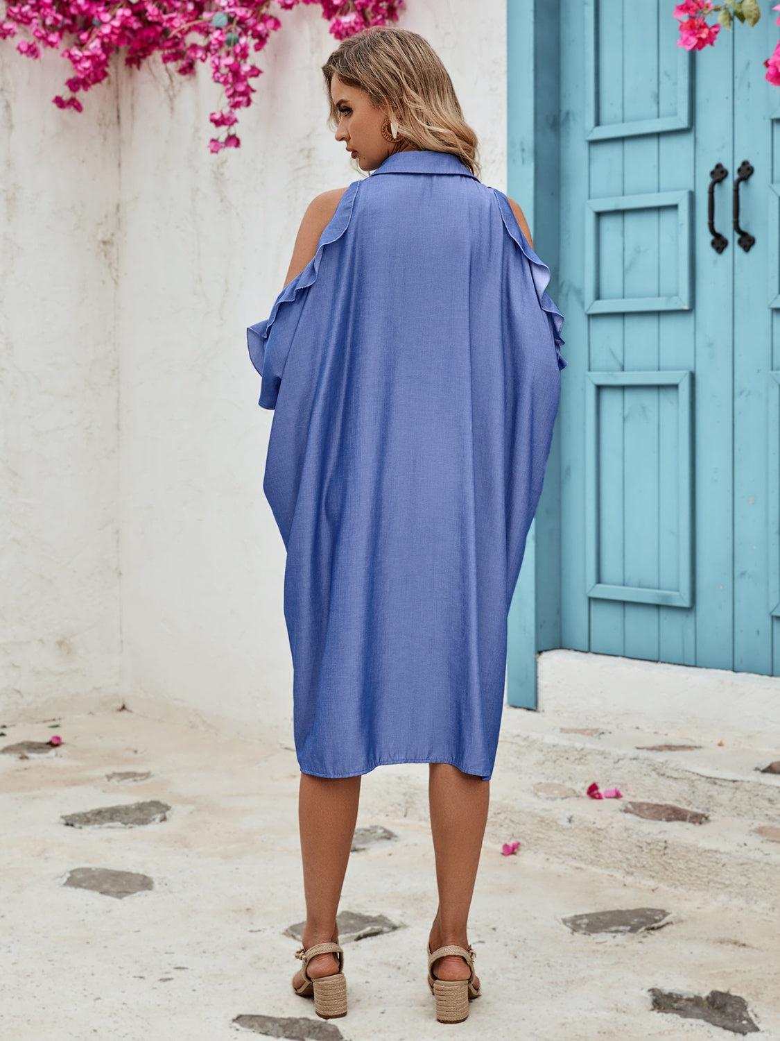 a woman standing in front of a blue door