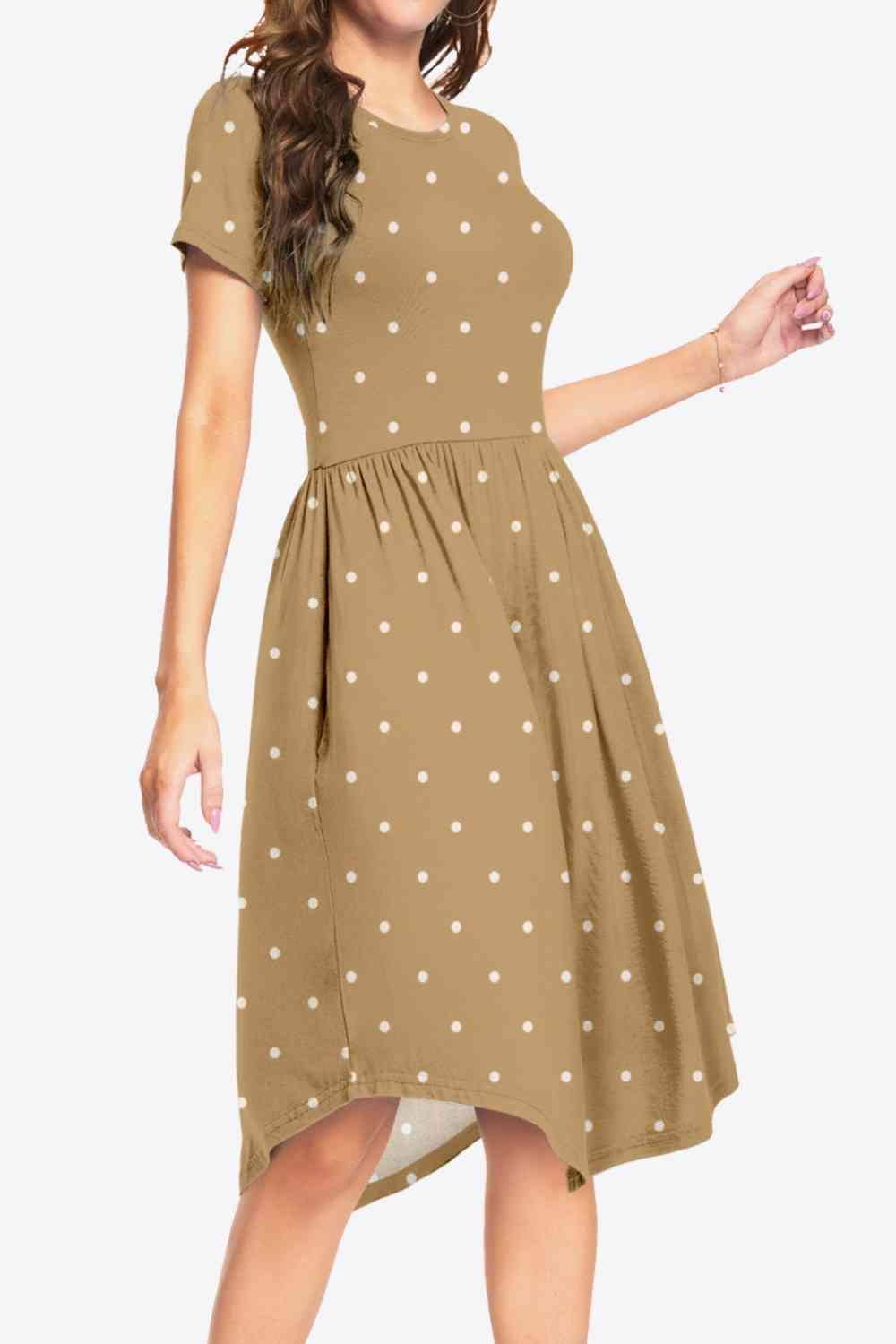 a woman wearing a brown dress with white polka dots