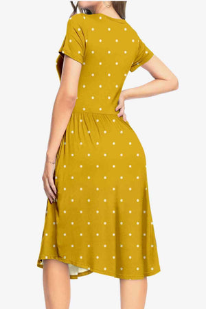 a woman wearing a yellow polka dot dress