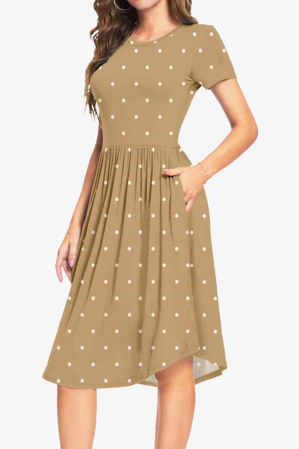 a woman wearing a brown dress with white polka dots