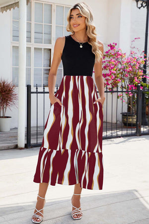 a woman in a black top and a red and white skirt