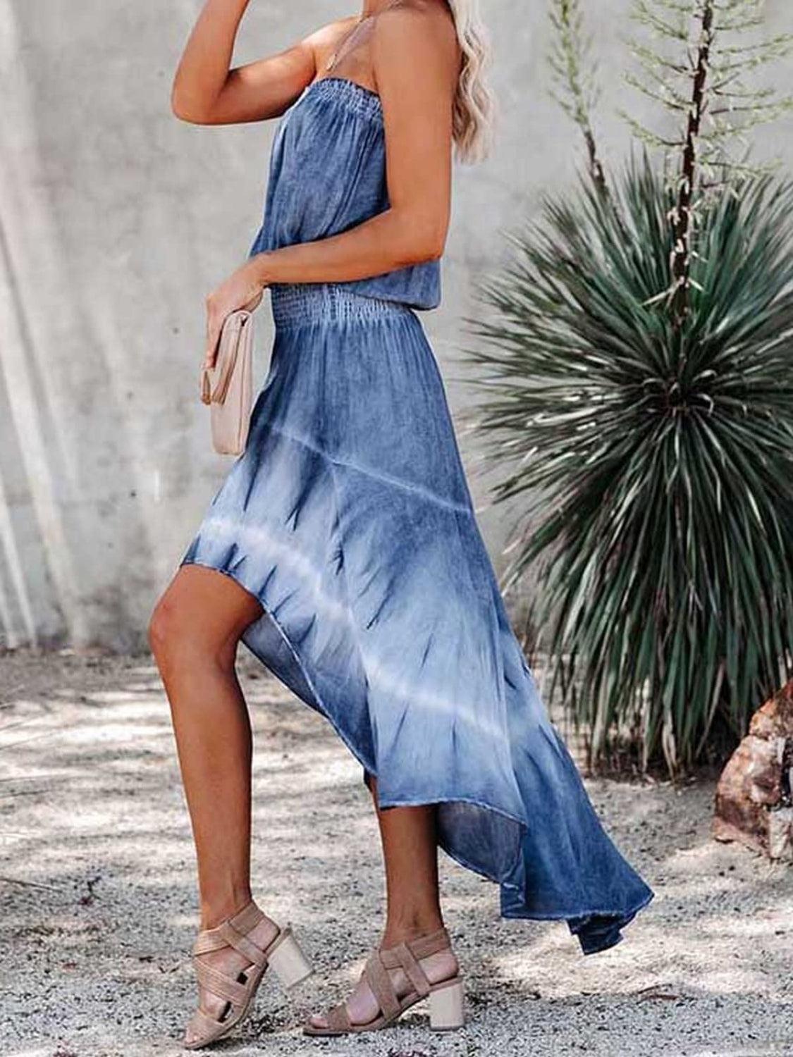 a woman wearing a blue tie dye dress