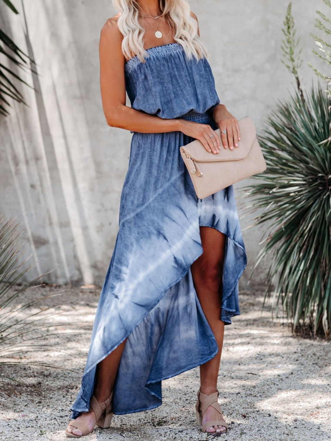 a woman wearing a blue tie dye dress