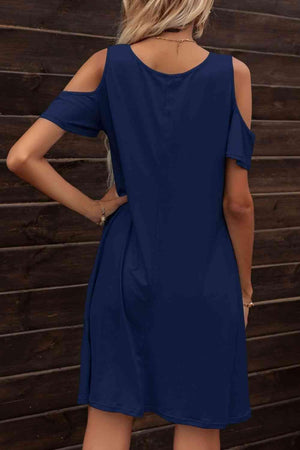 the back of a woman wearing a blue dress