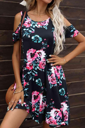 a woman wearing a floral print dress