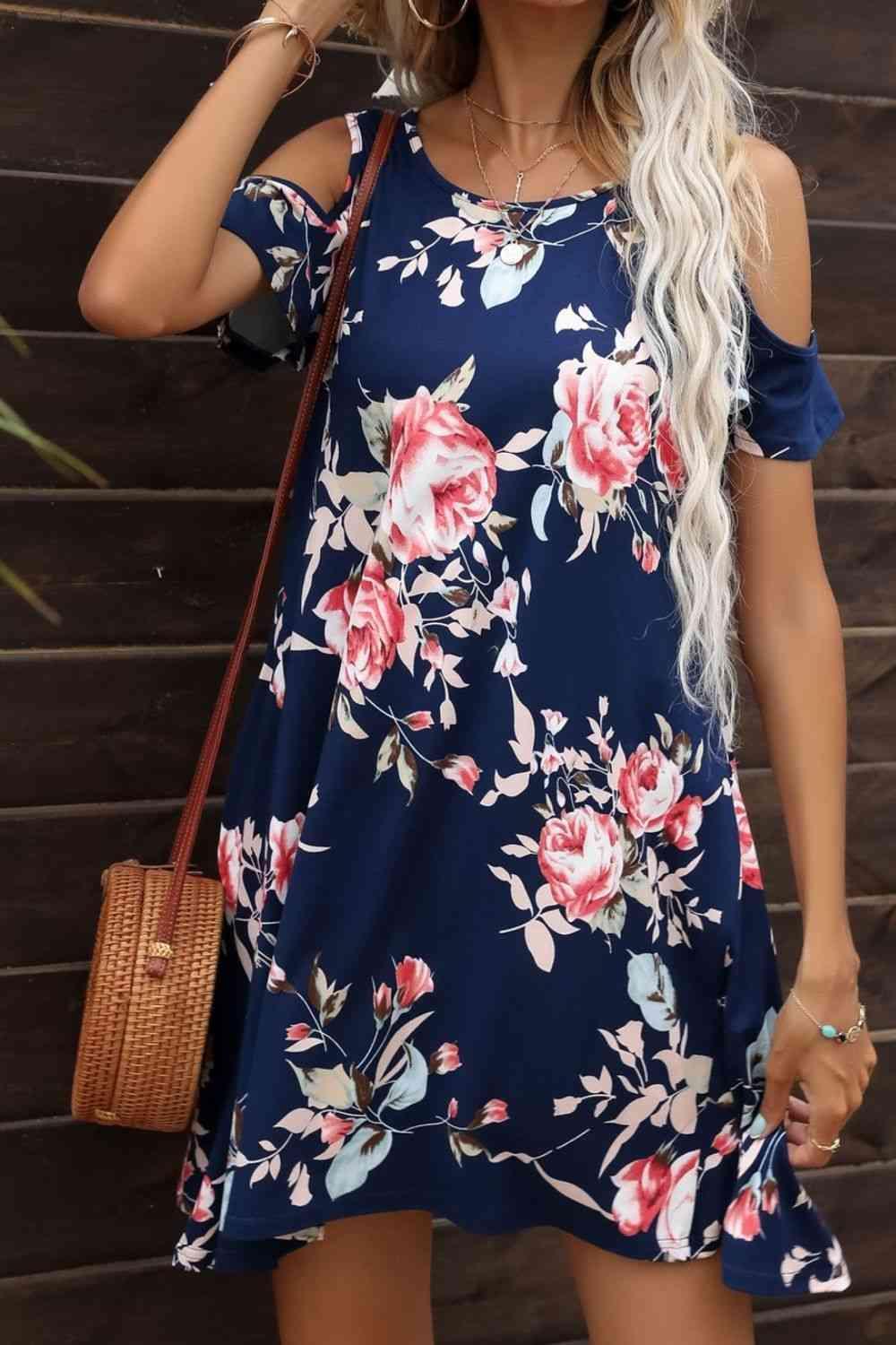 a woman wearing a blue floral print dress