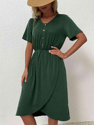 a woman wearing a green dress and a straw hat