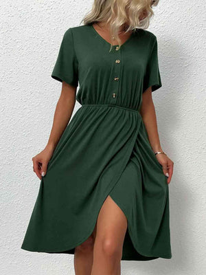 a woman wearing a green dress and sandals