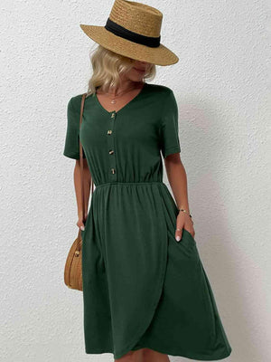 a woman wearing a green dress and a straw hat