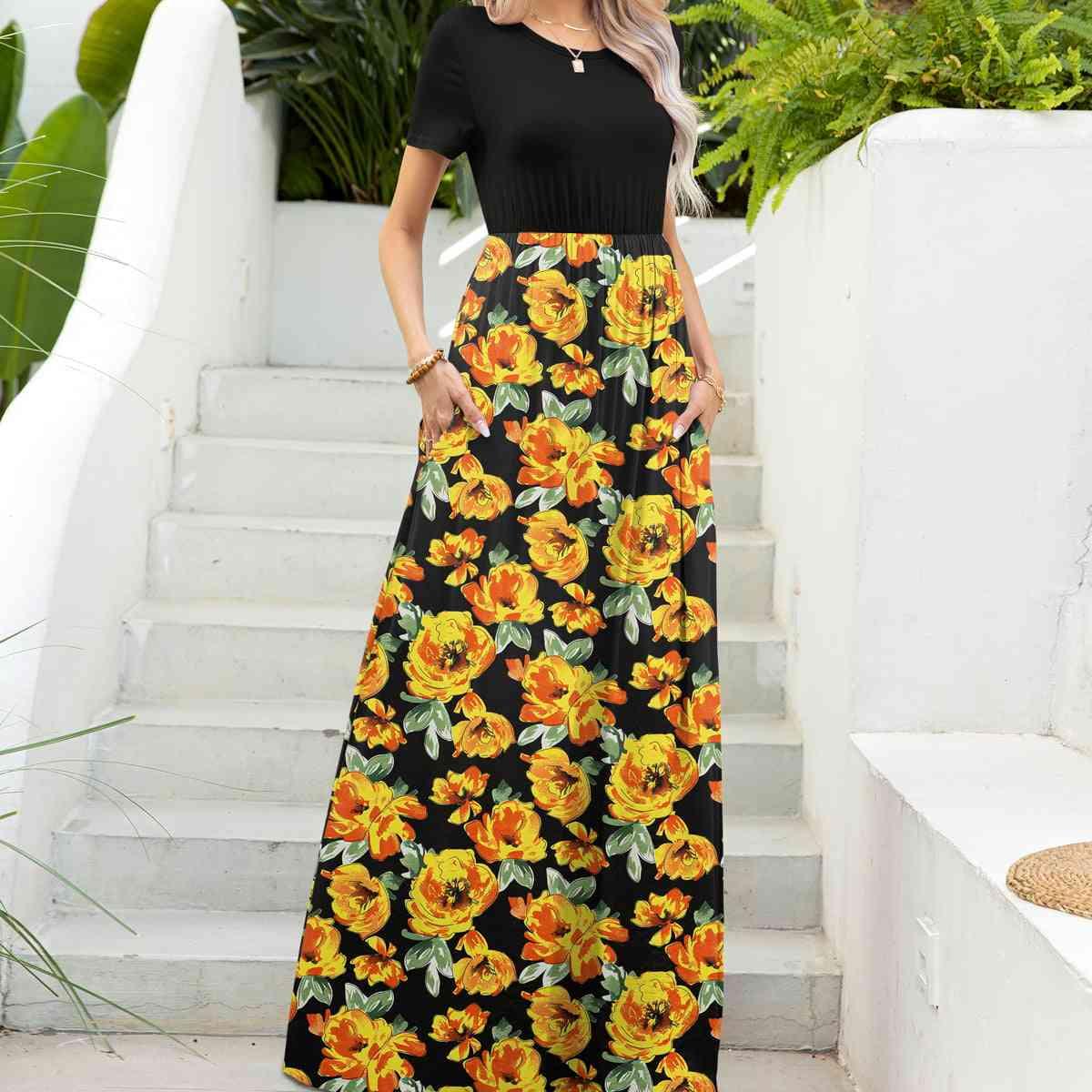 a woman wearing a black and yellow floral print skirt