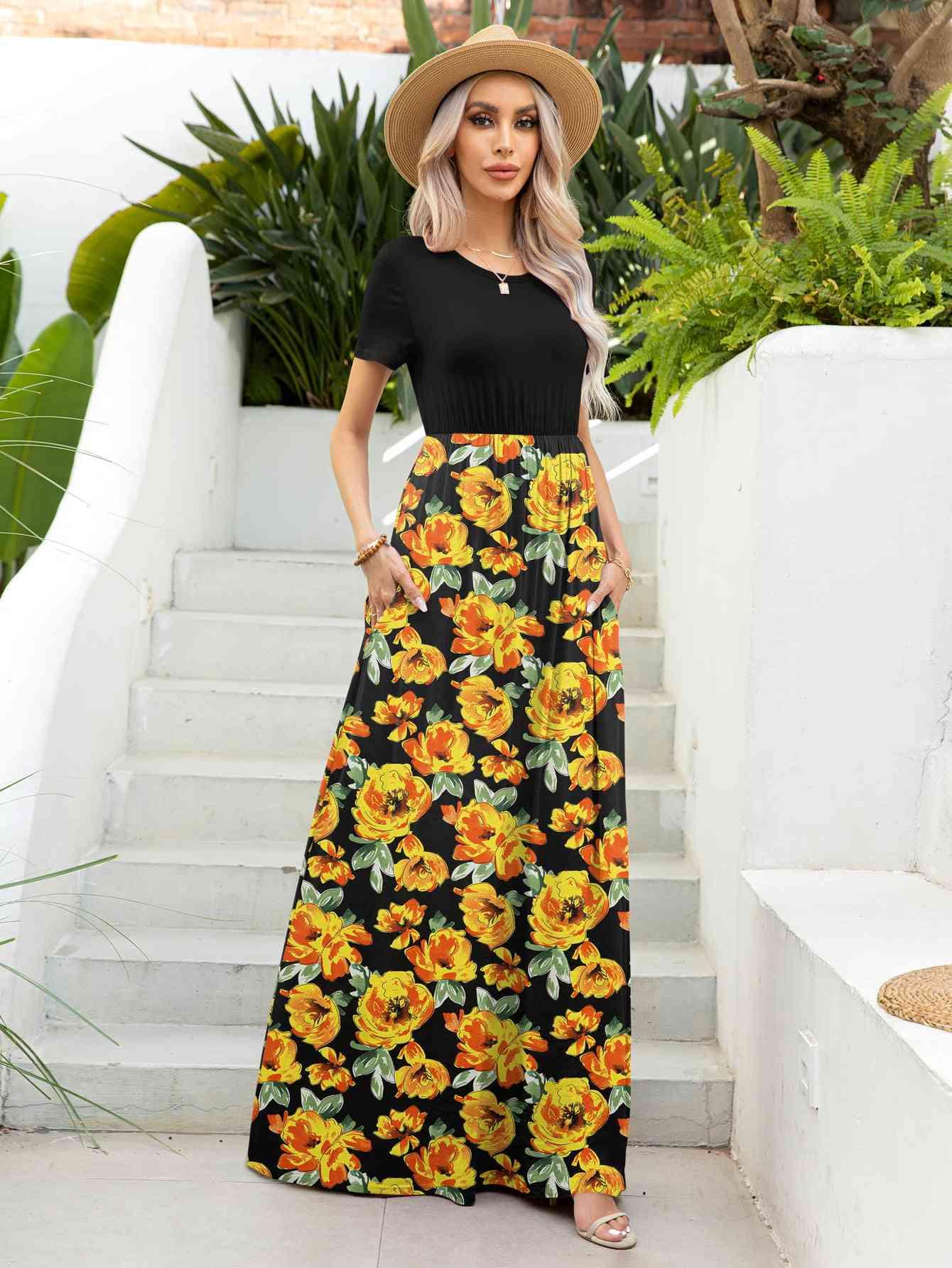 a woman wearing a black top and yellow floral skirt