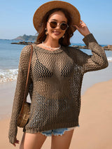 a woman wearing a hat and sunglasses on the beach