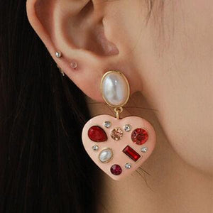 a close up of a person wearing a pair of earrings