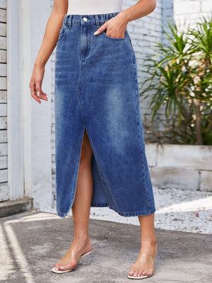 a woman in a white tank top and blue denim skirt