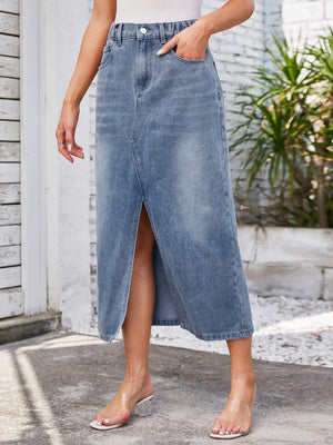 a woman in a white top and blue denim skirt