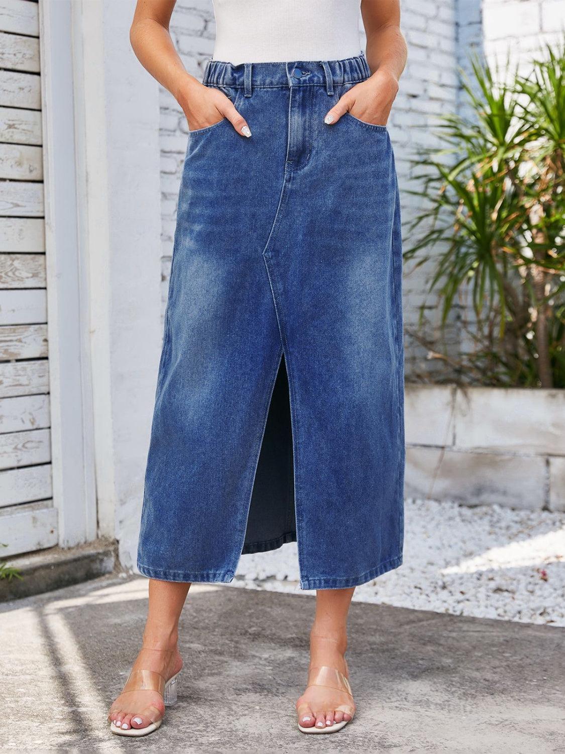 a woman wearing a white top and blue denim skirt