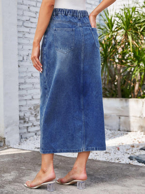 a woman in a white top and blue denim skirt