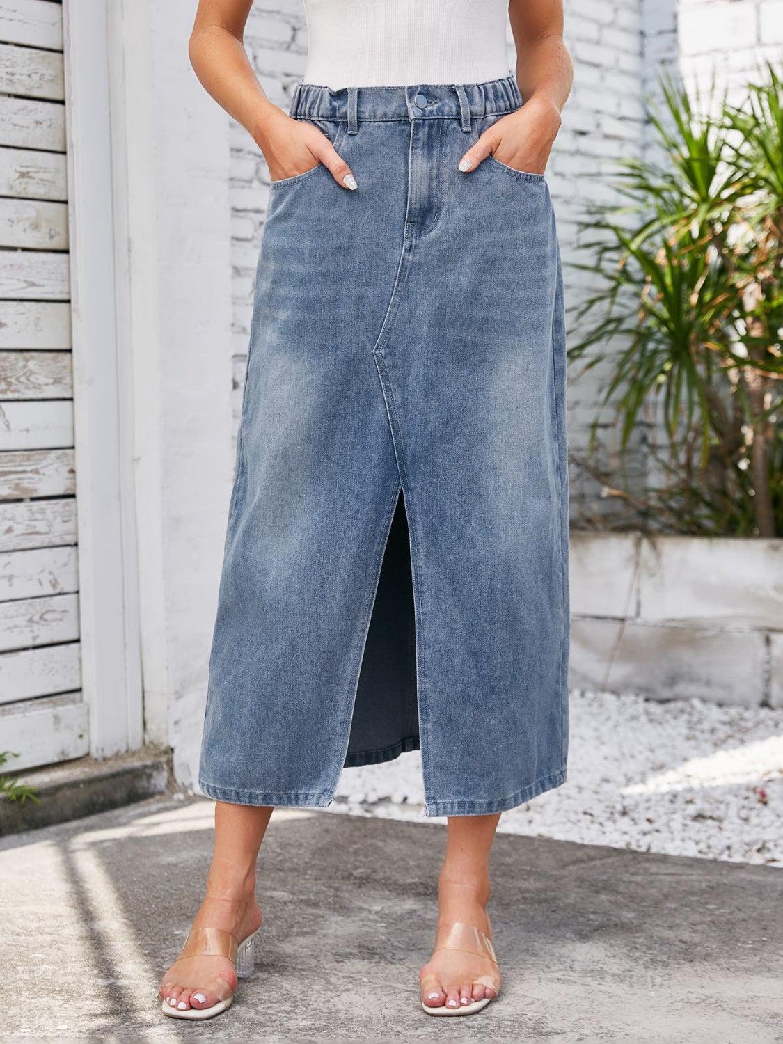 a woman in a white tank top and blue denim skirt