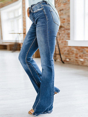 a woman in a blue shirt and jeans is dancing