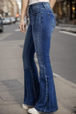 a woman standing on the side of a street