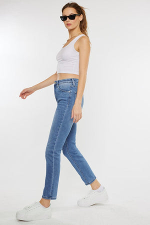 a woman in white top and jeans walking