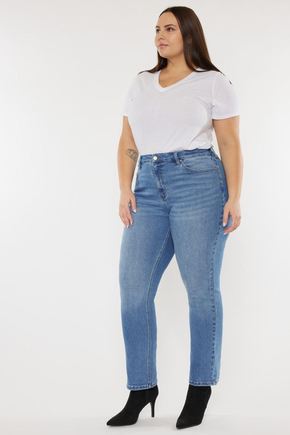 a woman wearing a white t - shirt and jeans