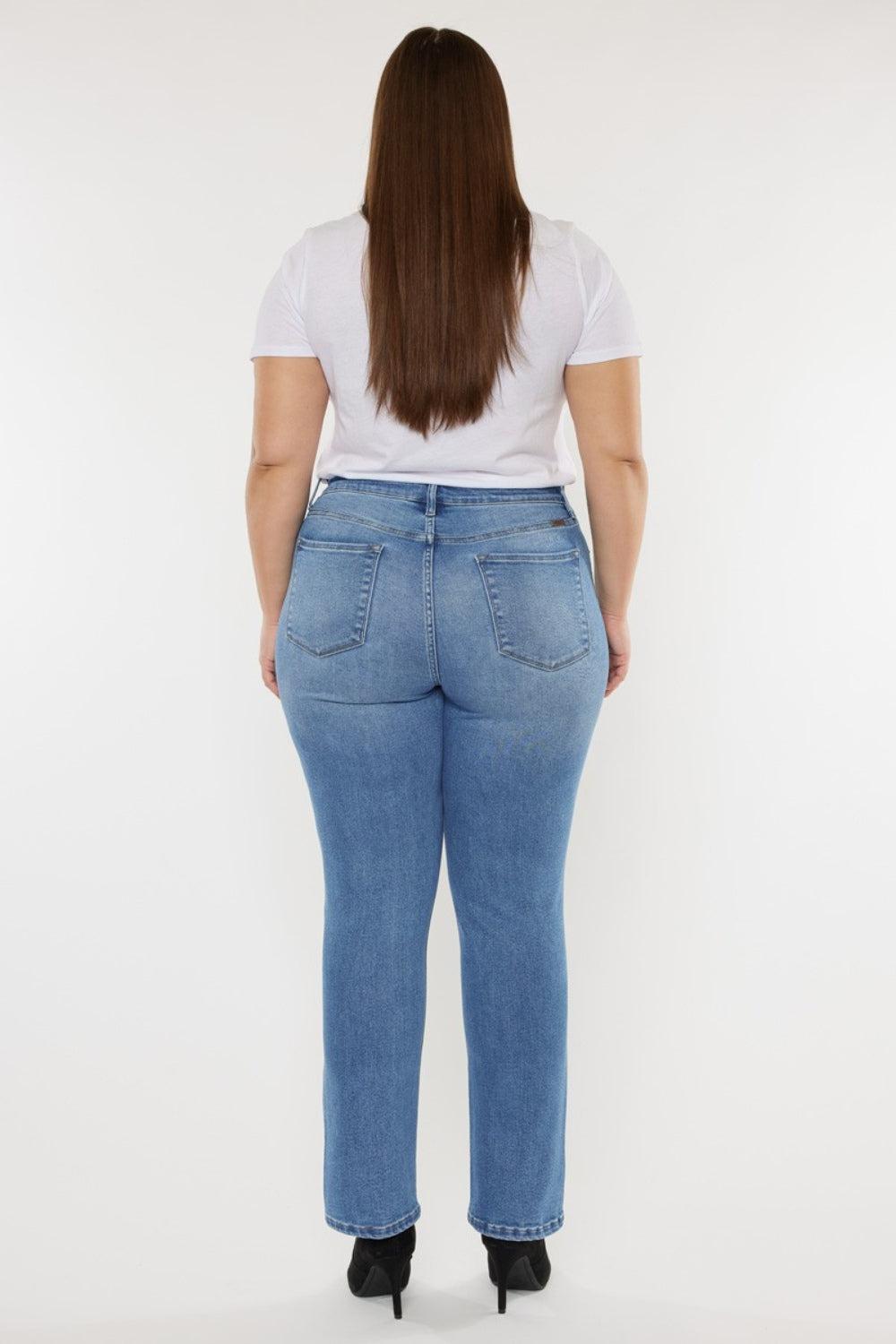 the back of a woman in a white shirt and jeans