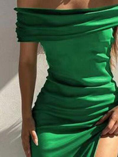 a woman in a green dress posing for the camera