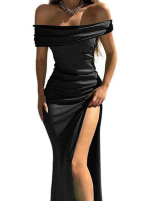 a woman in a black dress with a slited skirt