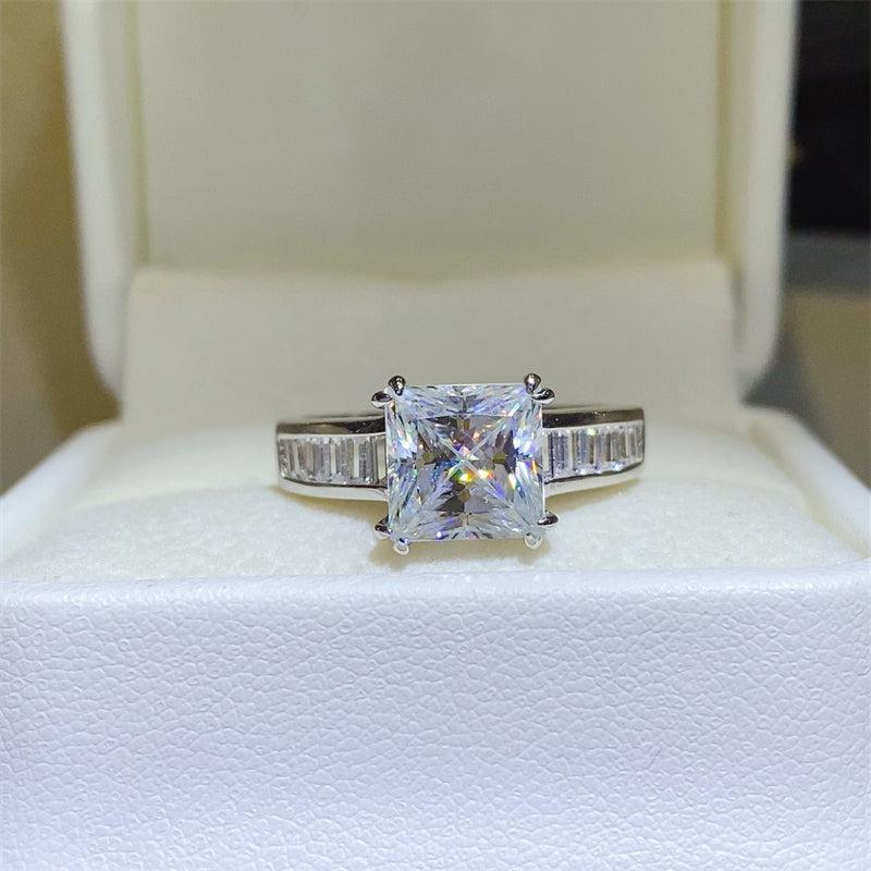 a white gold ring with a princess cut diamond