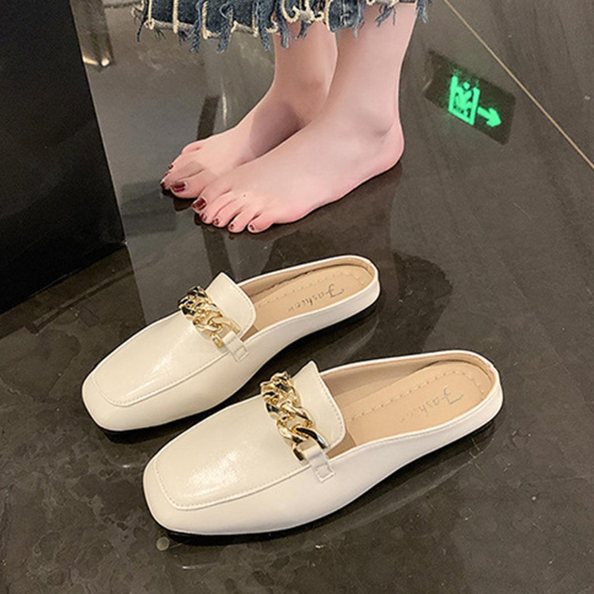 a woman's feet with a pair of white shoes