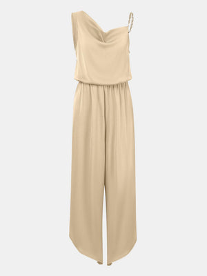 a woman is wearing a beige jumpsuit