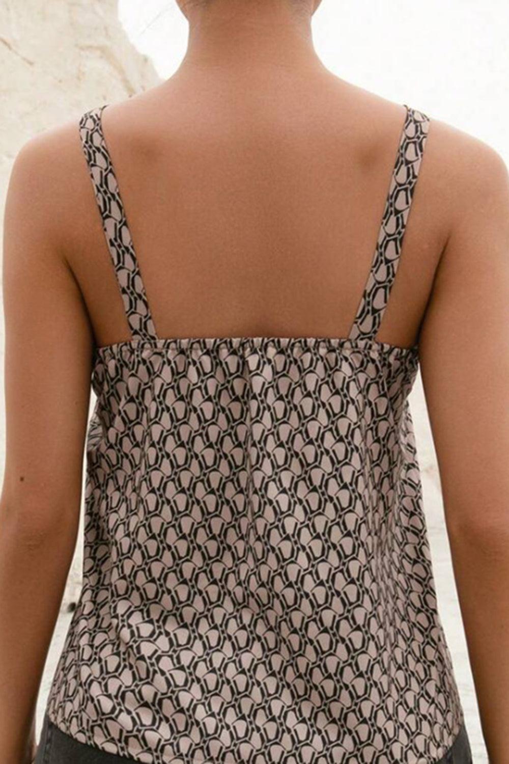 the back of a woman's top with a pattern on it